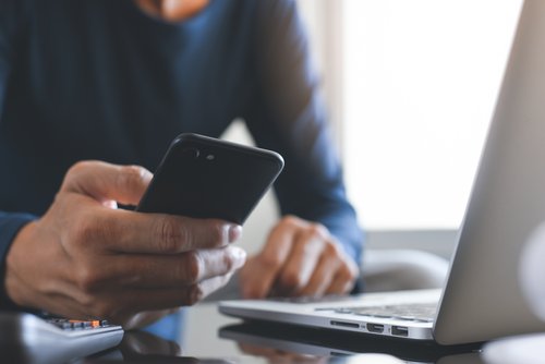 Man with laptop and mobile phone