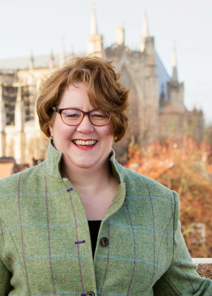 Sue Jefferson in a green checked coat with the York Minster in the background