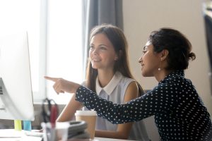 Stock image of two women talking - one appearing to give the other one advice