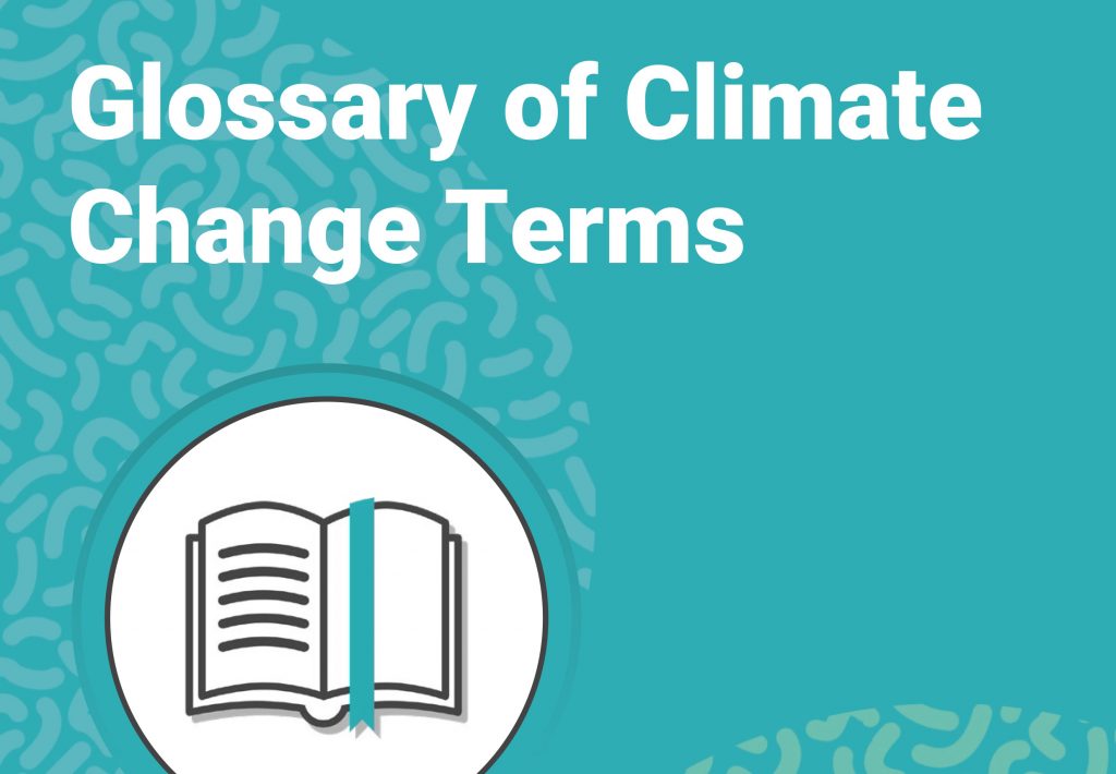 Climate change glossary terms written on a blue background with a image of a book underneath.